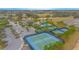 Aerial view of the community center, pool, tennis courts, bocce ball, and parking area at 1987 Key Bay Trl, Kissimmee, FL 34747