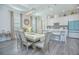 Dining room with a large table, neutral decor, and hardwood floors at 1987 Key Bay Trl, Kissimmee, FL 34747