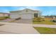Two-car garage and landscaped front yard at 1987 Key Bay Trl, Kissimmee, FL 34747