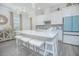 Modern kitchen with white cabinets, quartz countertops, and a large island at 1987 Key Bay Trl, Kissimmee, FL 34747