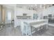 Modern kitchen with white cabinets, large island, and a view of the entryway at 1987 Key Bay Trl, Kissimmee, FL 34747
