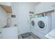 Laundry room with washer, dryer, and utility sink at 1987 Key Bay Trl, Kissimmee, FL 34747