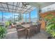 Covered patio features an outdoor kitchen, dining area, and comfortable seating at 1987 Key Bay Trl, Kissimmee, FL 34747