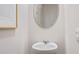 Small powder room with pedestal sink and oval mirror at 2223 Tongass Bnd, Davenport, FL 33896
