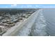 Expansive aerial view of coastline and neighborhood at 2401 S Atlantic Ave # C306, New Smyrna Beach, FL 32169
