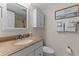 Bathroom with granite vanity and white cabinetry at 2401 S Atlantic Ave # C306, New Smyrna Beach, FL 32169