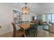 Dining area with a rustic wooden table and four chairs at 2401 S Atlantic Ave # C306, New Smyrna Beach, FL 32169