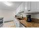 Clean kitchen featuring granite countertops and white cabinets at 2401 S Atlantic Ave # C306, New Smyrna Beach, FL 32169