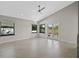 Bright living room with large windows, tile floors and access to patio at 2660 Bent Hickory Cir, Longwood, FL 32779
