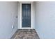 Gray front door with a welcome mat and brick walkway at 2789 Ruby Rose Ln, St Cloud, FL 34771