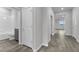 Gray hallway with wood-look tile flooring and bathroom access at 2789 Ruby Rose Ln, St Cloud, FL 34771