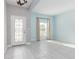 Light filled entryway boasts decorative glass door, tile floors, and soft blue walls at 2918 Sand Oak Loop, Apopka, FL 32712