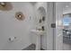 Simple, clean powder room with pedestal sink and decorative mirror at 3330 Thicket St, Tavares, FL 32778