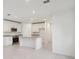 White kitchen with an island and stainless steel appliances at 3330 Thicket St, Tavares, FL 32778