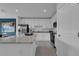 Modern kitchen with white cabinets, granite countertops, and stainless steel appliances at 3332 Thicket St, Tavares, FL 32778
