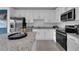 Modern kitchen with white cabinets, granite countertops, and stainless steel appliances at 3332 Thicket St, Tavares, FL 32778