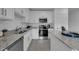 Modern kitchen featuring stainless steel appliances and granite countertops at 3332 Thicket St, Tavares, FL 32778