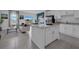 Open concept kitchen with stainless steel appliances and an island at 3332 Thicket St, Tavares, FL 32778