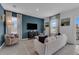 Bright living room features stylish sofa, armchair, and a large TV at 3332 Thicket St, Tavares, FL 32778