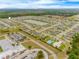 Aerial view of community, showcasing homes, a pond, and pool at 3548 Patron Ave, Deltona, FL 32738