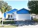 Cute blue house with white garage door and well-maintained lawn at 429 Copperstone Cir, Casselberry, FL 32707