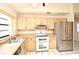 Galley kitchen with wood cabinets, stainless steel appliances, and tile floor at 429 Copperstone Cir, Casselberry, FL 32707
