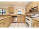 L-shaped kitchen with wood cabinets and stainless steel appliances at 429 Copperstone Cir, Casselberry, FL 32707