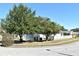 Landscaped side yard with mature trees and a white fence at 429 Copperstone Cir, Casselberry, FL 32707