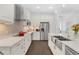 Bright kitchen with white cabinets, quartz countertops, and a farmhouse sink at 433 Carolina Ave, Winter Park, FL 32789