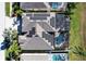 Aerial view of house featuring solar panels, pool, and fenced patio at 437 Prestwick Dr, Davenport, FL 33897