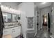 Elegant bathroom with granite countertop, updated vanity and walk-in closet at 437 Prestwick Dr, Davenport, FL 33897
