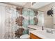 Clean bathroom with shower/tub combo and floral shower curtain at 437 Prestwick Dr, Davenport, FL 33897