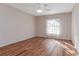 Simple bedroom with wood flooring, ceiling fan, and window at 437 Prestwick Dr, Davenport, FL 33897