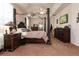 Bright bedroom with a large bed, dresser, and plenty of space at 437 Prestwick Dr, Davenport, FL 33897