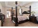 Spacious Primary bedroom with a large four poster bed and plenty of natural light at 437 Prestwick Dr, Davenport, FL 33897