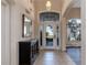 Bright entryway with tile flooring, dark wood console table, and mirror at 437 Prestwick Dr, Davenport, FL 33897
