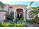 Two-story house with inviting front entry and lush landscaping at 437 Prestwick Dr, Davenport, FL 33897