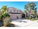 Two-story house with three-car garage, landscaping, and palm trees at 437 Prestwick Dr, Davenport, FL 33897
