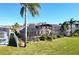 Home with solar panels, screened pool, and lush landscaping at 437 Prestwick Dr, Davenport, FL 33897