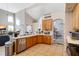 L-shaped kitchen with stainless steel appliances and wood cabinets at 437 Prestwick Dr, Davenport, FL 33897