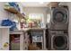 Laundry room with washer, dryer, and ample storage shelves at 437 Prestwick Dr, Davenport, FL 33897