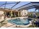 Screened pool and patio area with lush landscaping and outdoor seating at 437 Prestwick Dr, Davenport, FL 33897