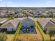 Aerial view showing home with backyard patio and solar panels at 4538 Cortland Dr, Davenport, FL 33837