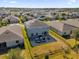 Aerial view of a house with solar panels and a backyard patio at 4538 Cortland Dr, Davenport, FL 33837
