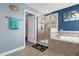Spa-like bathroom with soaking tub, walk-in shower, and tile flooring at 4538 Cortland Dr, Davenport, FL 33837