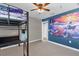 Charming bedroom with bunk bed, ocean mural, and ceiling fan at 4538 Cortland Dr, Davenport, FL 33837