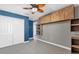 Bright bedroom with ceiling fan, built-in shelves, and double closet at 4538 Cortland Dr, Davenport, FL 33837