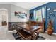 Dining room features a rustic wood table with benches and ocean-themed decor at 4538 Cortland Dr, Davenport, FL 33837