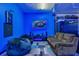 Game room with comfy seating, large screen, and blue LED lighting at 4538 Cortland Dr, Davenport, FL 33837