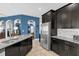 Modern kitchen with dark wood cabinets, granite countertops, and stainless steel appliances at 4538 Cortland Dr, Davenport, FL 33837